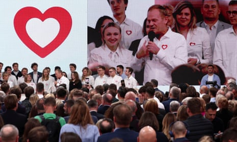Supporters and leaders of the largest opposition grouping, Civic Coalition (KO), react to exit polls as Donald Tusk, KO’s leader, gives a speech after the announcement of exit poll results in Warsaw on 15 October.